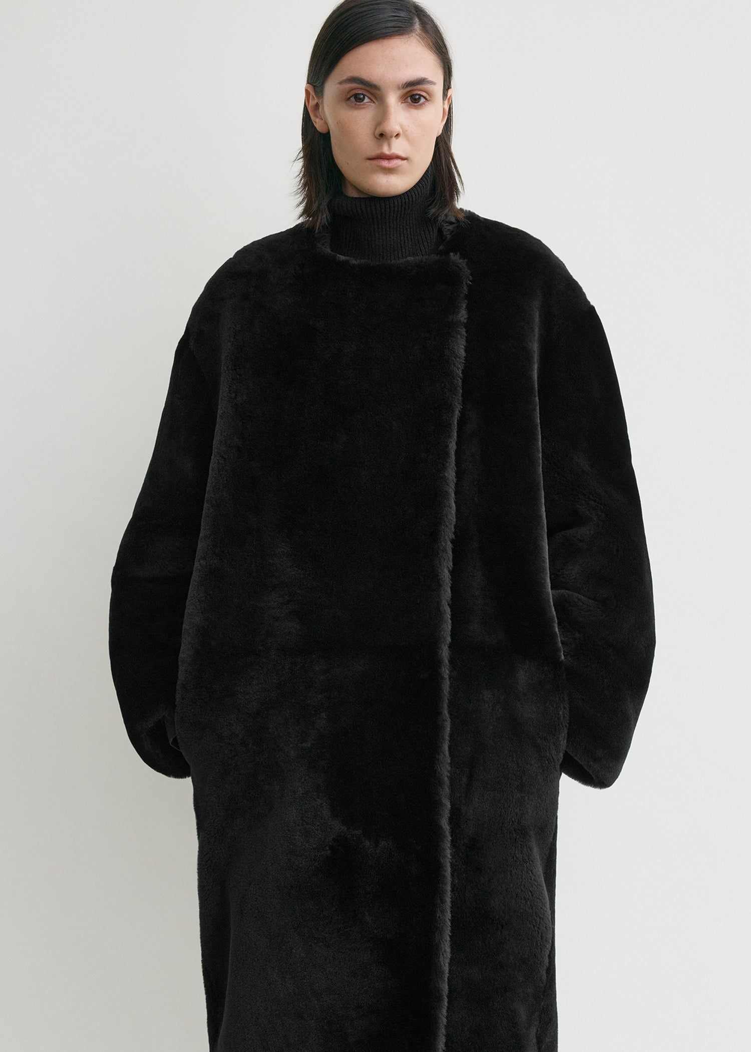 Collarless shearling coat black