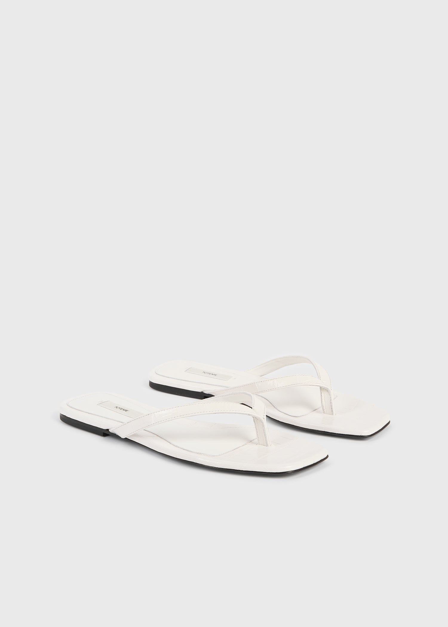 Croco-embossed flip flops off-white