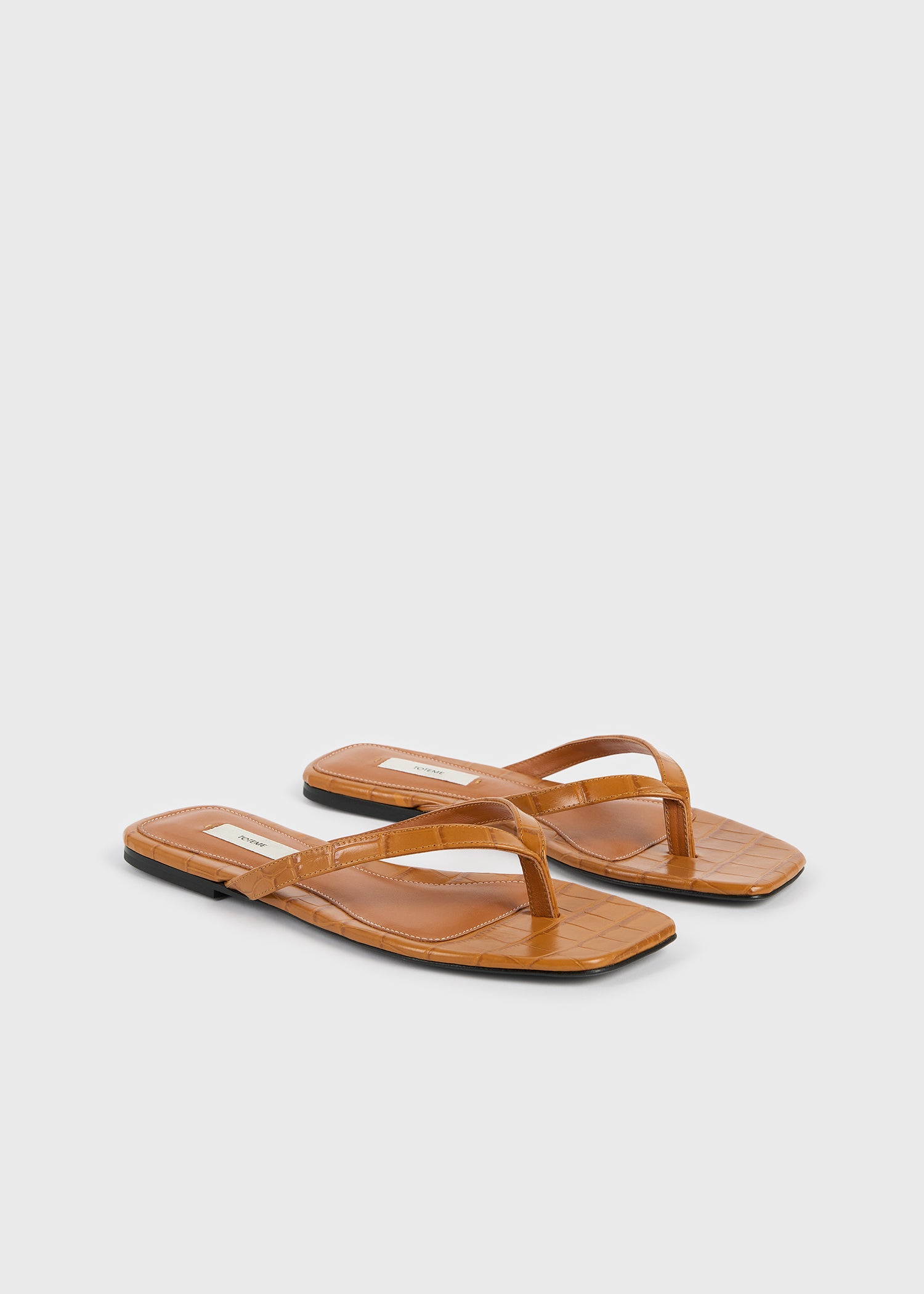 Croco-embossed flip flops tangerine
