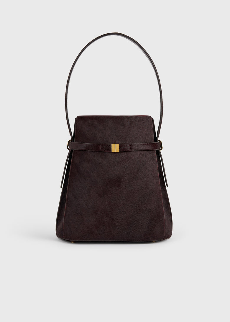 Belted pony hair bucket bag wine